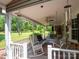 Covered porch with comfortable seating, perfect for enjoying the serene backyard views at 409 Ridge Rd, Clover, SC 29710