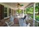 Inviting covered porch with rocking chairs and fans, offering a relaxing outdoor space at 409 Ridge Rd, Clover, SC 29710