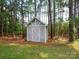 Outdoor shed surrounded by mature trees, offering additional storage space for tools and equipment at 409 Ridge Rd, Clover, SC 29710