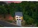 Beautiful new construction duplex surrounded by mature trees with a long driveway and black garage doors at 4117 Sarah Dr, Charlotte, NC 28217