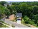 Aerial view of modern homes surrounded by lush greenery and trees at 4117 Sarah Dr, Charlotte, NC 28217