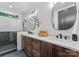 Modern bathroom featuring a double vanity, sleek mirrors, and a glass-enclosed shower at 4117 Sarah Dr, Charlotte, NC 28217