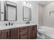 Bathroom features a double sink vanity with dark wood cabinets at 4117 Sarah Dr, Charlotte, NC 28217