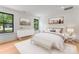Cozy bedroom showcasing natural light, a decorative bench, and a stylish accent wall art at 4117 Sarah Dr, Charlotte, NC 28217