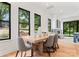 Features dining area with large windows, comfortable seating, and modern decor with view into the open floor plan at 4117 Sarah Dr, Charlotte, NC 28217