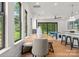 Modern dining area with large windows, stylish table and chairs, open to kitchen and living areas with an outdoor view at 4117 Sarah Dr, Charlotte, NC 28217