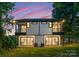 Rear exterior showcasing the outdoor living space, including balconies and sliding glass doors for natural light at 4117 Sarah Dr, Charlotte, NC 28217