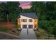 Stunning modern home exterior with clean lines, contrasting materials, and a double garage at 4117 Sarah Dr, Charlotte, NC 28217