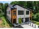 Modern duplex showing wood and white accents, with black trim and a well-maintained yard at 4117 Sarah Dr, Charlotte, NC 28217