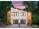 Modern duplex featuring a combination of white, wood, and black accents and a well-manicured front yard at 4117 Sarah Dr, Charlotte, NC 28217