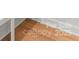 Close-up of beautifully finished light hardwood flooring with pristine white trim at 4117 Sarah Dr, Charlotte, NC 28217