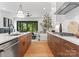 Contemporary kitchen with sleek cabinets, stainless steel appliances, and an open view to the living area and backyard at 4117 Sarah Dr, Charlotte, NC 28217