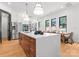 A modern kitchen island with seating and stainless steel appliances is the focal point of the combined kitchen and dining area at 4117 Sarah Dr, Charlotte, NC 28217