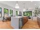 Features a modern kitchen island with bar stool seating, open to the living room, and dining room with outdoor views at 4117 Sarah Dr, Charlotte, NC 28217