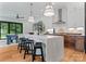 A modern kitchen island is the focal point, featuring pendant lighting and seating, in the open-concept living space at 4117 Sarah Dr, Charlotte, NC 28217
