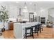 Features kitchen with stylish island, barstool seating, modern stainless appliances, and sleek cabinets at 4117 Sarah Dr, Charlotte, NC 28217