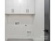 Bright laundry room offers plenty of storage space with white cabinets at 4117 Sarah Dr, Charlotte, NC 28217