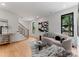 Contemporary living room with staircase, stylish sofa, and modern decor accents at 4117 Sarah Dr, Charlotte, NC 28217