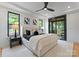 Relaxing main bedroom with tray ceiling, balcony access, and sleek black framed windows at 4117 Sarah Dr, Charlotte, NC 28217