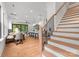 Bright, open floor plan features modern staircase, hardwood floors, and a combined dining, kitchen, and living area at 4117 Sarah Dr, Charlotte, NC 28217