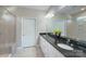 Spacious bathroom featuring double sinks with granite countertops, a glass-enclosed shower, and bright lighting at 4333 Legacy Dr, Denver, NC 28037