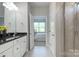 Bright bathroom with a granite countertop vanity leading to a bedroom with ample natural light at 4333 Legacy Dr, Denver, NC 28037