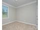 Cozy bedroom with neutral walls, carpet flooring, and a window offering plenty of natural light at 4333 Legacy Dr, Denver, NC 28037