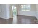 Dining room with modern light fixture, hardwood floors, and a sliding glass door leading to the backyard at 4333 Legacy Dr, Denver, NC 28037