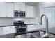 Well-equipped kitchen with white cabinets, stainless steel appliances, and a stylish faucet at 4333 Legacy Dr, Denver, NC 28037