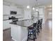 Modern kitchen featuring an island with dark countertops, stainless steel appliances, and white cabinetry at 4333 Legacy Dr, Denver, NC 28037