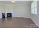 Spacious living room with a fireplace, hardwood floors, and large windows at 4333 Legacy Dr, Denver, NC 28037