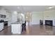 Spacious open-concept layout with kitchen, island seating, and living area with fireplace at 4333 Legacy Dr, Denver, NC 28037