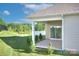 A covered patio extends living outdoors with a concrete floor and views of the landscaped lawn at 4333 Legacy Dr, Denver, NC 28037