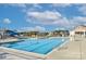 A large community swimming pool with a slide, lounge chairs, and a clear blue sky at 4333 Legacy Dr, Denver, NC 28037