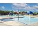 Community splash pad with a blue mushroom fountain, slide, and chairs for Gathering fun at 4333 Legacy Dr, Denver, NC 28037
