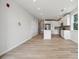 Spacious, light-filled living area with wood flooring and an open floor plan leading to a modern kitchen at 4455 Reed Creek Dr # 203, Sherrills Ford, NC 28673