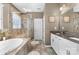 Spa-like bathroom featuring a soaking tub, walk-in glass shower, dual sinks, and modern fixtures at 5059 Fenwick Ct, Lancaster, SC 29720