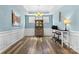 Bright dining room featuring modern chandelier, wood floors, and stylish wainscoting at 5059 Fenwick Ct, Lancaster, SC 29720