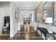 Elegant entryway features beautiful hardwood floors, wainscoting, and stylish wallpaper, leading into the inviting living space at 5059 Fenwick Ct, Lancaster, SC 29720