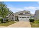 Charming single-Gathering home with stone accents, a two-car garage, and manicured lawn at 5059 Fenwick Ct, Lancaster, SC 29720