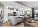 Open-concept kitchen boasting white cabinets, a center island, and pendant lighting, seamlessly connected to the living space at 5059 Fenwick Ct, Lancaster, SC 29720