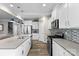 Modern kitchen with white cabinets, stainless steel appliances, an island with sink, and stylish backsplash at 5059 Fenwick Ct, Lancaster, SC 29720