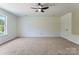 Spacious bedroom featuring plush carpet, a ceiling fan, and a window offering natural light at 5229 Tarrywood Ln, Charlotte, NC 28205