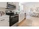 Updated kitchen boasts stainless steel appliances and pristine white cabinetry at 5229 Tarrywood Ln, Charlotte, NC 28205
