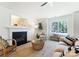 Bright living room featuring a fireplace, natural fiber rug and a ceiling fan at 5229 Tarrywood Ln, Charlotte, NC 28205
