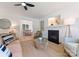 Bright living room featuring a fireplace, neutral decor and a ceiling fan at 5229 Tarrywood Ln, Charlotte, NC 28205