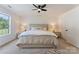 Spacious primary bedroom with plush carpet, ceiling fan and a large window at 5229 Tarrywood Ln, Charlotte, NC 28205