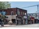 Eclectic street view featuring brick buildings with vibrant murals, shops, and a construction crane backdrop at 5229 Tarrywood Ln, Charlotte, NC 28205