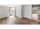 Finished basement with wood-look flooring and access to the outside, plus a view of living area through doorway at 5354 Sherrills Ford Rd, Catawba, NC 28609