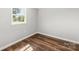 Well-lit bedroom featuring hardwood floors and a view of the outdoors at 5354 Sherrills Ford Rd, Catawba, NC 28609